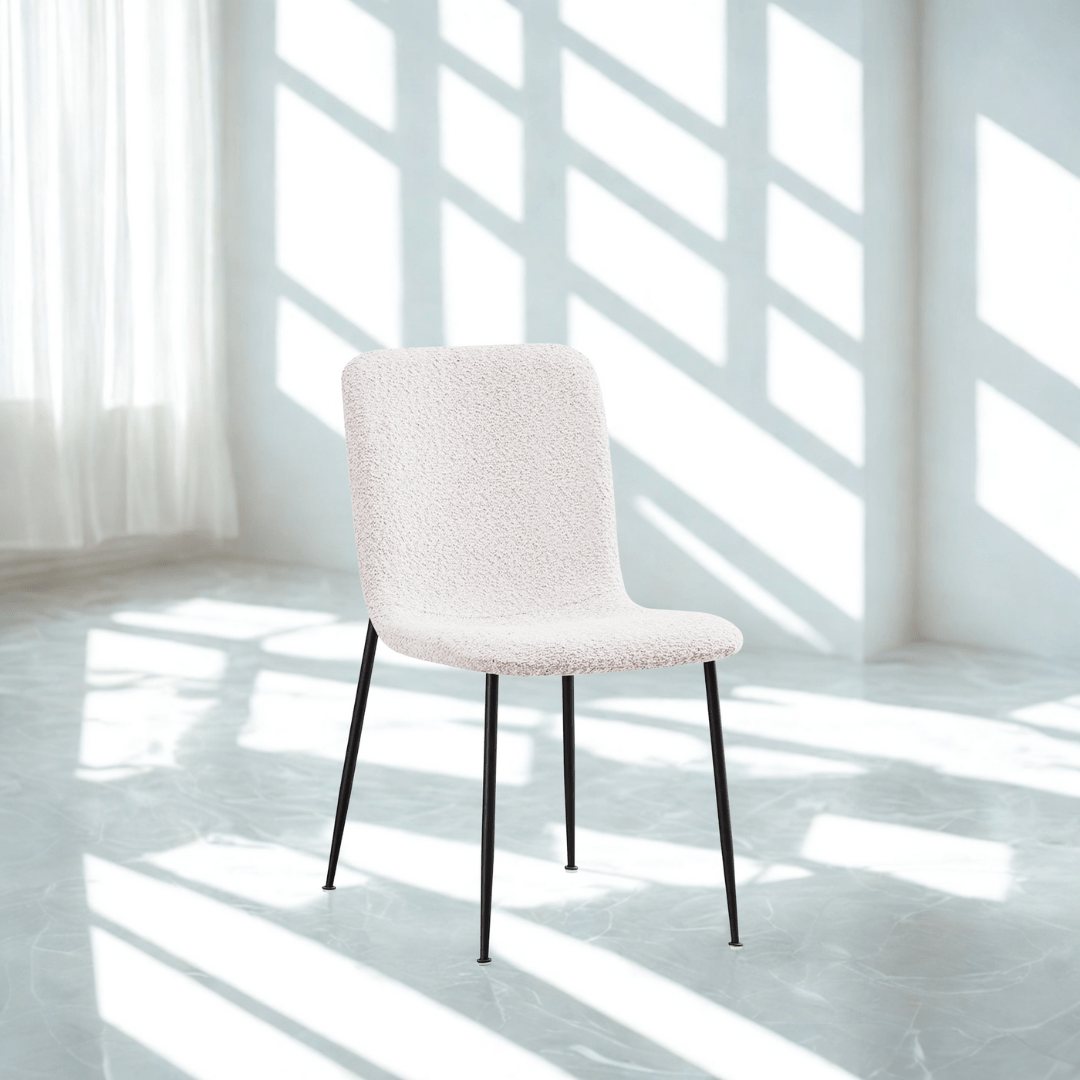 White chair in a bright room with sunlight filtering through the windows.