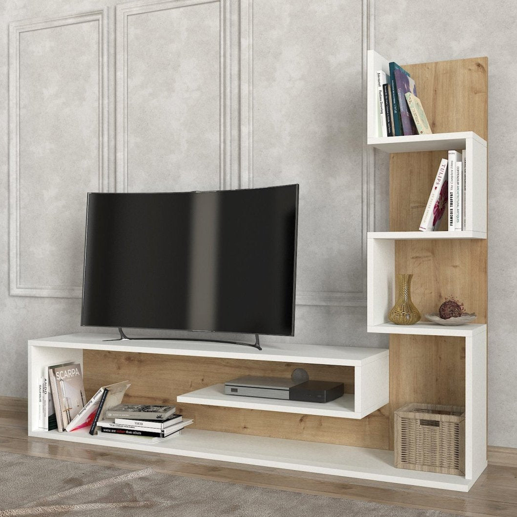 A modern white and light wood TV stand and shelving unit against a textured gray wall, styled with a black television, books, and decorative accessories.