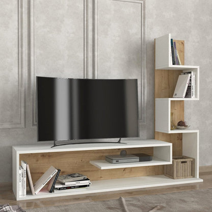 A modern white and light wood TV stand console with open shelves, styled with a black curved television, books, and a cable box, set against a textured gray wall.