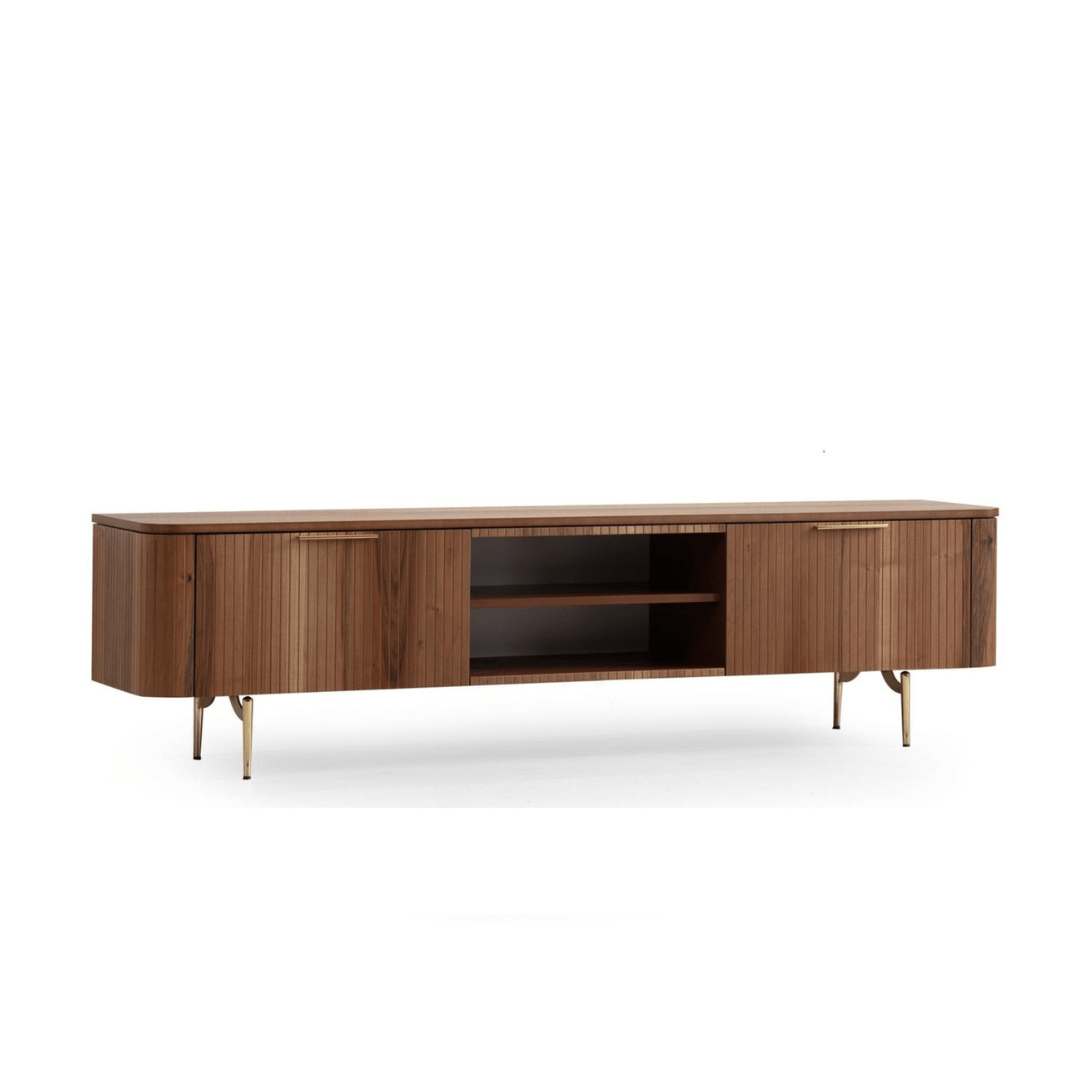 Asta Wooden Tv Unit 200cm. Front view of the wide, contemporary wood media console, featuring two large storage cabinets with vertical slatted texture and small gold handles, surrounding open central shelving, supported by short gold angled metal legs.