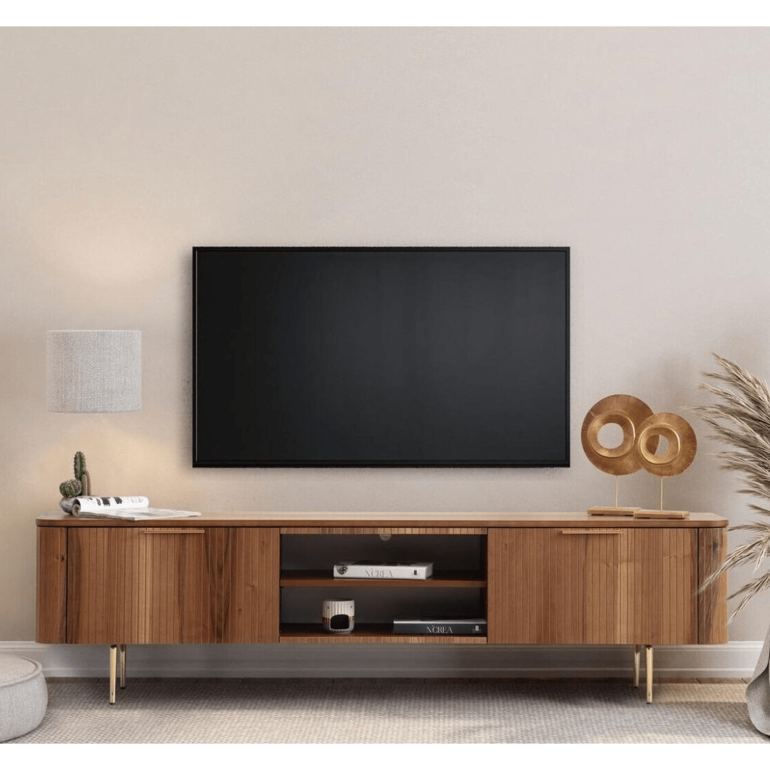 Asta Wooden Tv Unit 200cm. Wide, contemporary wood media console featuring vertical slatted cabinet doors on both ends and open central shelving with two shelves, supported by short gold angled metal legs beneath a wall-mounted TV.