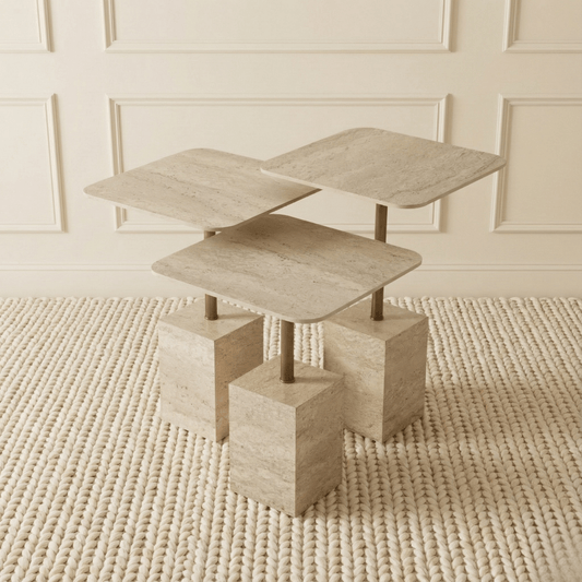 Modern travertine nesting side tables with geometric design on a textured rug