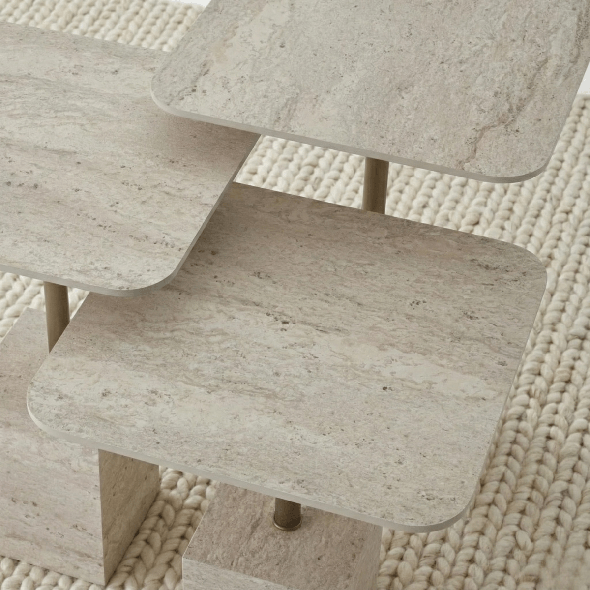 Close-up of a textured travertine tables top against a woven beige background