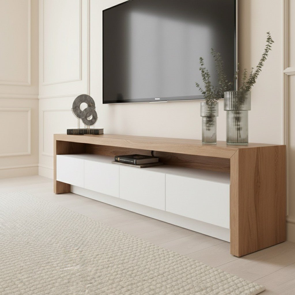 Dantone Tv Unit 200cm. Close-up, low-angle shot of the light wood and white media console, highlighting the thick wood top and side panels, the smooth, handleless white storage drawers below a central open shelf, and the base structure.