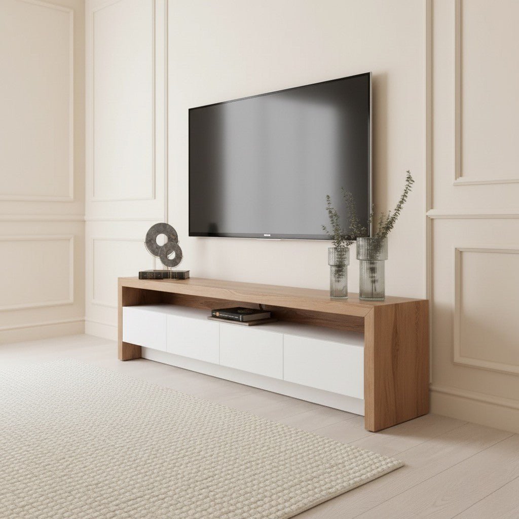 Dantone Tv Unit 200cm. Angled shot of the wide, contemporary media console with a light wood top and thick side panels, featuring four handleless white storage drawers below a central open shelf, placed beneath a mounted TV.