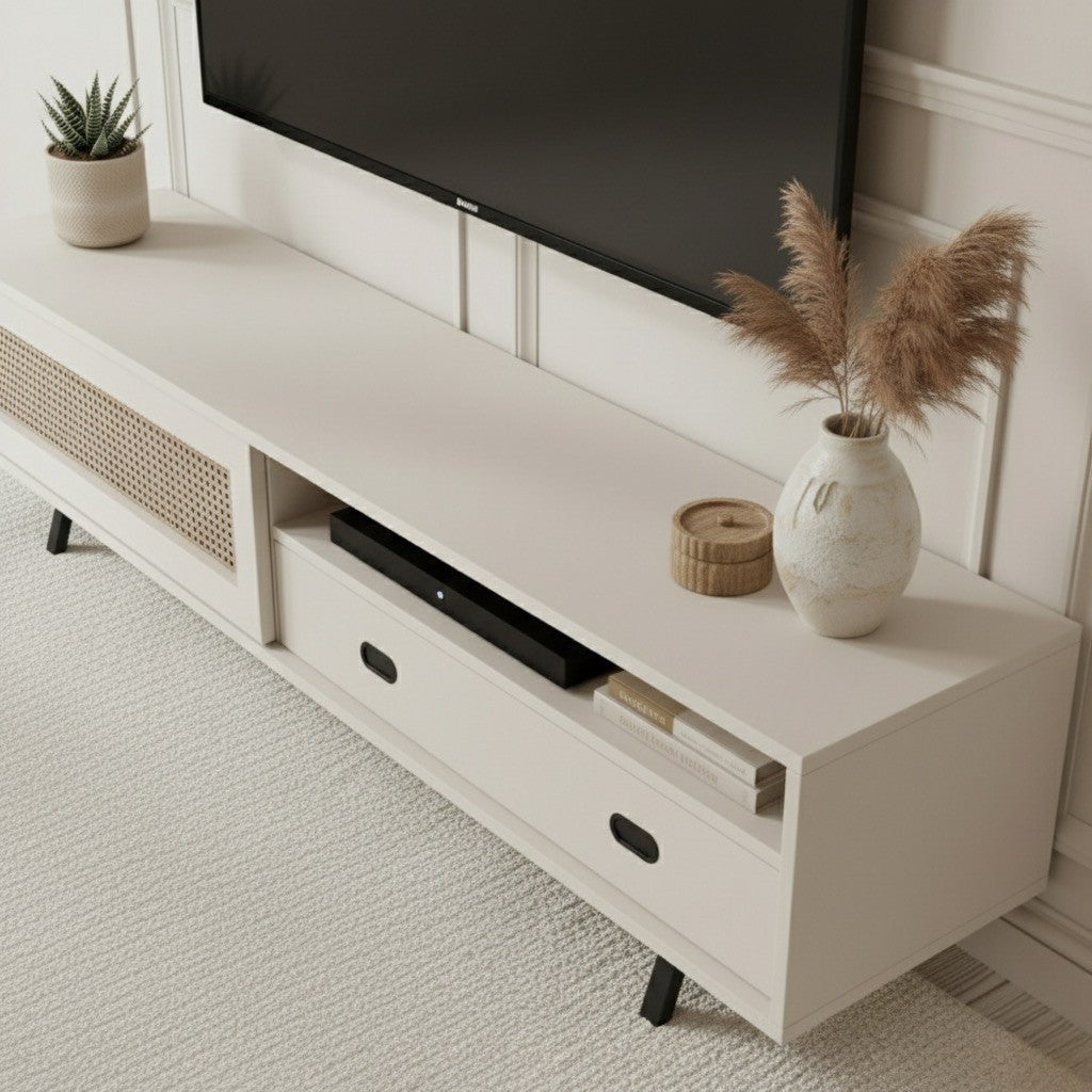 Finn Tv Unit Cream 200cm. Angled shot of the cream media console, showing the two open storage shelves, the two drawers with black oval pull handles (one of which is visible), and the printed cane-front cabinet door on the right, supported by black angled legs.