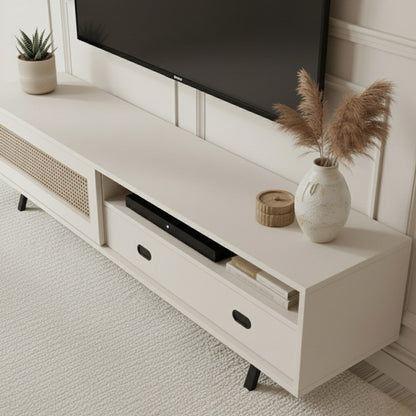 Finn Tv Unit Cream 200cm. Angled shot of the cream media console, showing the two open storage shelves, the two drawers with black oval pull handles (one of which is visible), and the printed cane-front cabinet door on the right, supported by black angled legs.