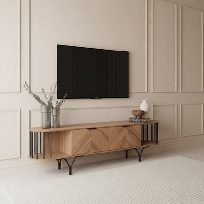 Foster TV Unit 200cm. Contemporary TV console made of wood with an elliptical top and base, featuring two central storage cabinets with eye-catching chevron-patterned wood doors. The sides have open shelving accented by decorative black vertical metal bars, all supported by unique black metal legs, offering a modern and organized focal point for media display.
