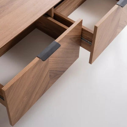 Foster TV Unit 200cm. High-angle close-up view showing two partially open drawers of the TV unit, made of light natural wood with a subtle chevron grain pattern. Each drawer features a long, modern black pull handle and a spacious white interior, emphasizing the unit's practical and high-quality hidden storage.