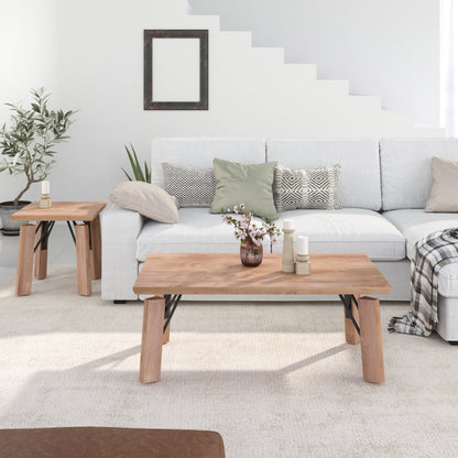 A modern living room scene featuring a light oak coffee table in the foreground, a matching side table on the left, and a white sectional sofa with decorative pillows in the background.