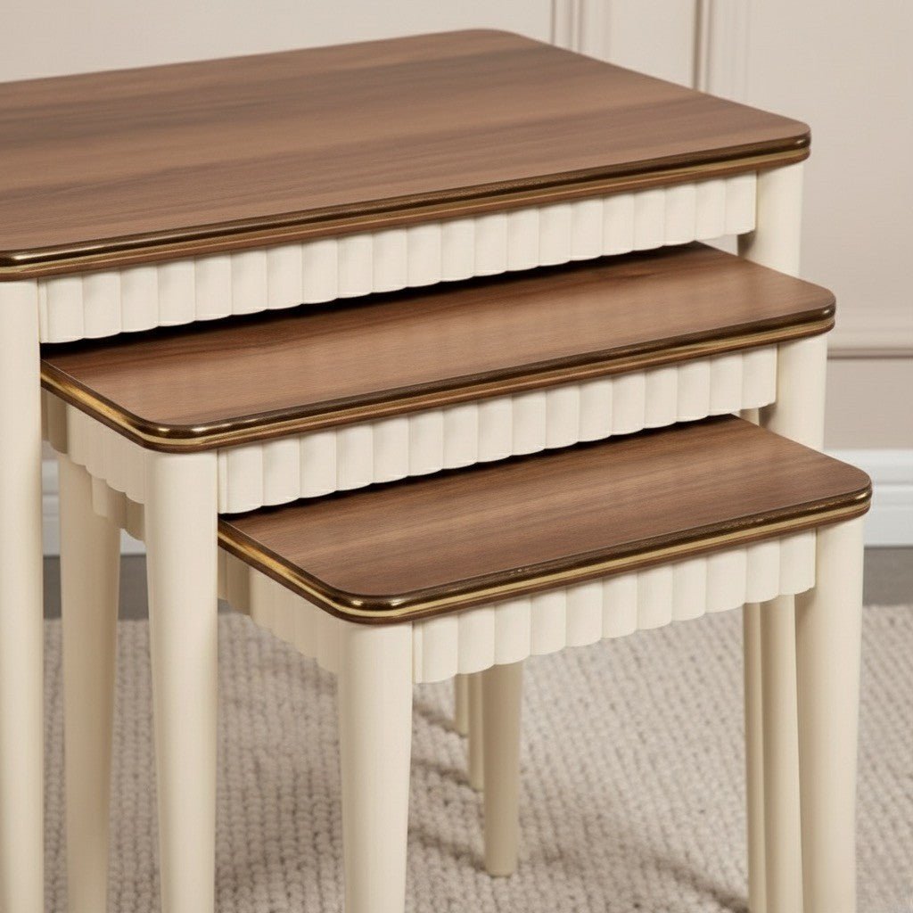 Set of four nesting tables with wooden tops and white bases on a neutral background