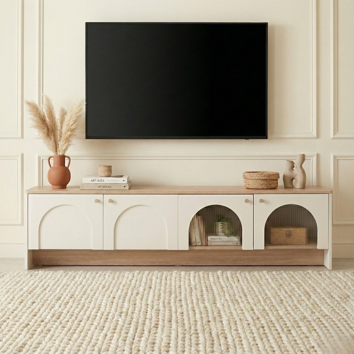 Modern entertainment console with a television mounted above it in a living room setting.