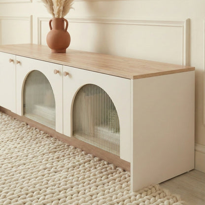 Modern living room with a wooden entertainment console, placed against a neutral wall.