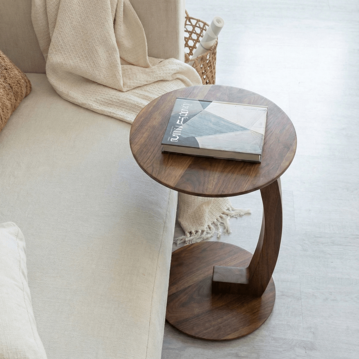 Wooden side table with a book on a beige sofa