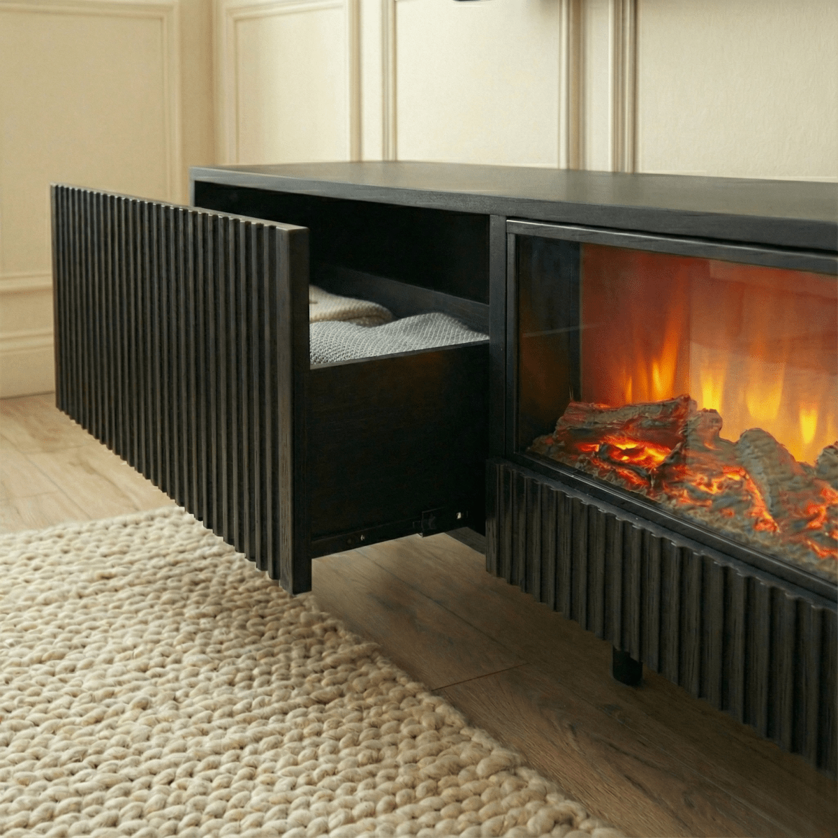 Modern electric fireplace with wooden logs and flames in a living room setting.