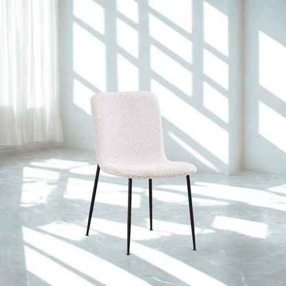 White chair in a bright room with sunlight filtering through the windows.