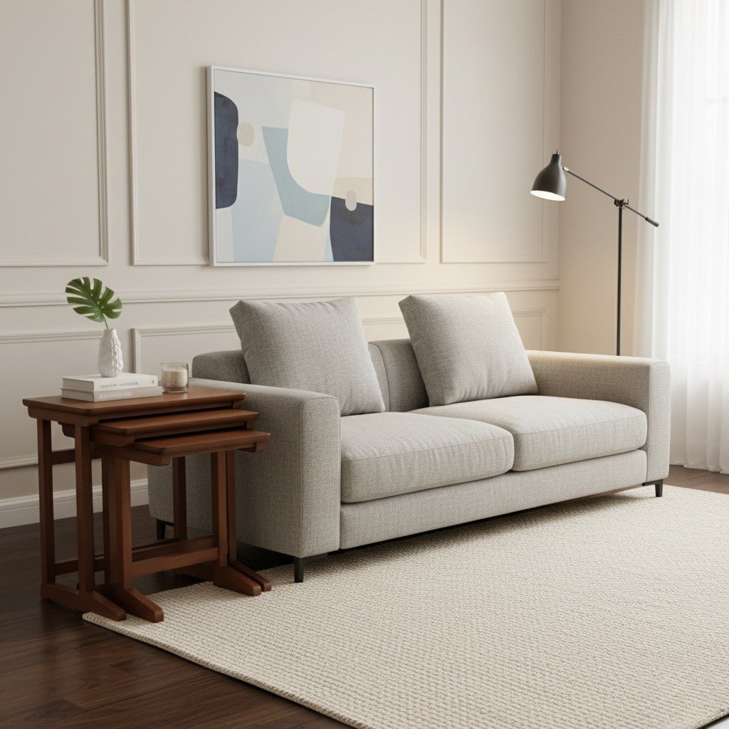 Modern living room with a gray sofa, wooden side table, and abstract art on the wall.