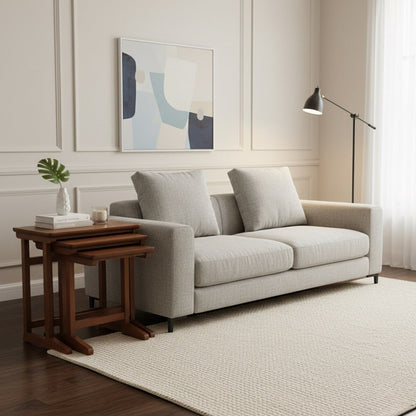 Modern living room with a gray sofa, wooden side table, and abstract art on the wall.