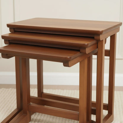 Set of three wooden nesting tables on a neutral background