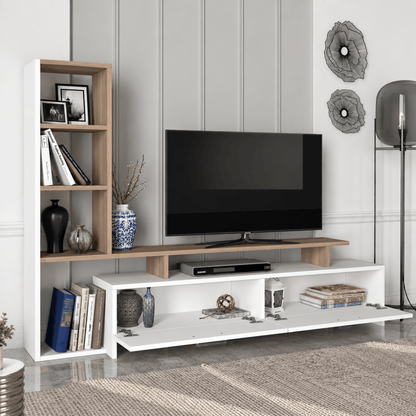 A modern white and light wood TV stand console with open shelving, styled in a living room setting with a flat-screen television, decorative vases, books, and a floor lamp.