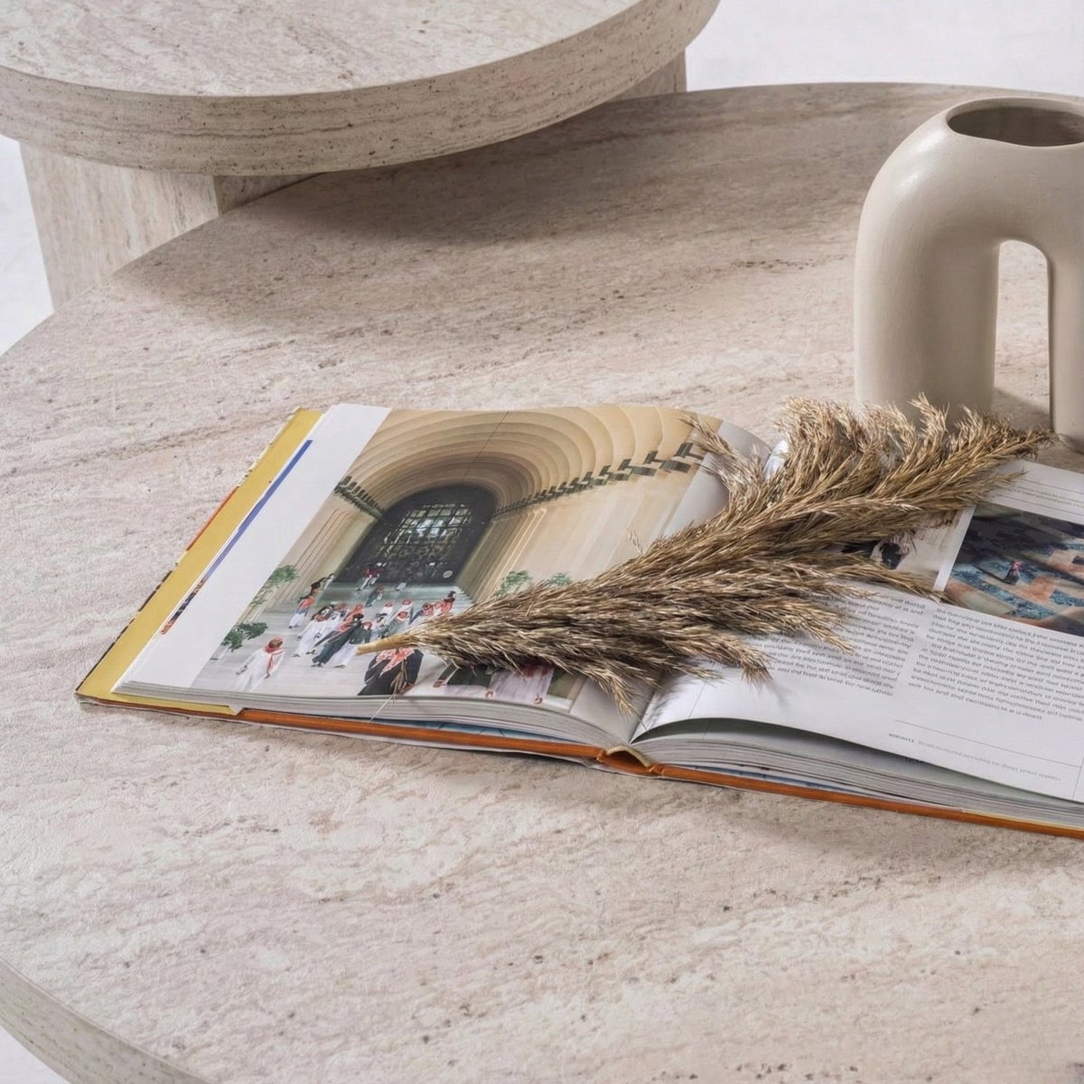 Open book on a stone surface with decorative elements