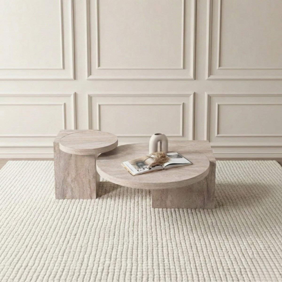 Modern Travertine coffee table with a magazine and decorative item against a neutral wall.