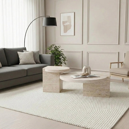 Modern living room with gray sofa, round coffee table, and floor lamp.