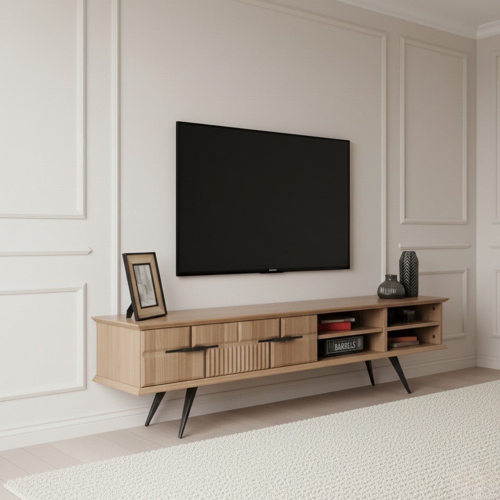 Tribe Wooden Tv Unit Walnut 200cm. Angled perspective of the mid-century modern light walnut media console featuring two central storage drawers (one ribbed, one smooth) with black pull handles, open shelving on the right, and supported by four black angled metal legs beneath a wall-mounted TV.