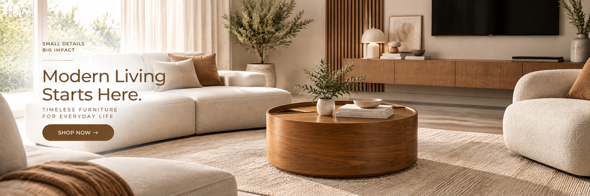 A modern living room scene with cream upholstered sectional sofa, round wooden coffee table, beige rug, wall-mounted TV, and warm wood accents. Text on the left reads 'Modern Living Starts Here.