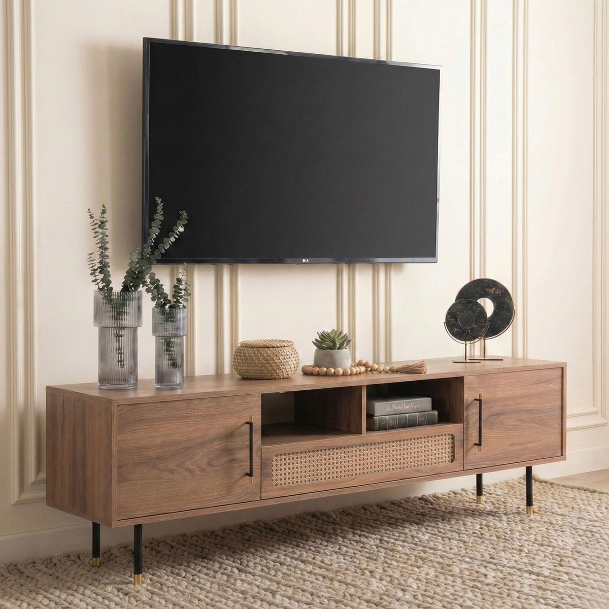 Wooden TV stand with a television mounted on a wall, featuring decorative items.