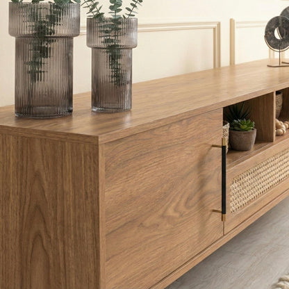 Wooden sideboard with decorative items including vases and plants.